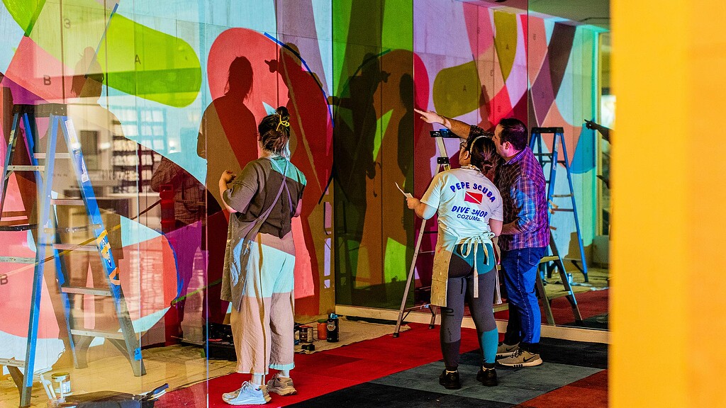 A group of people painting.