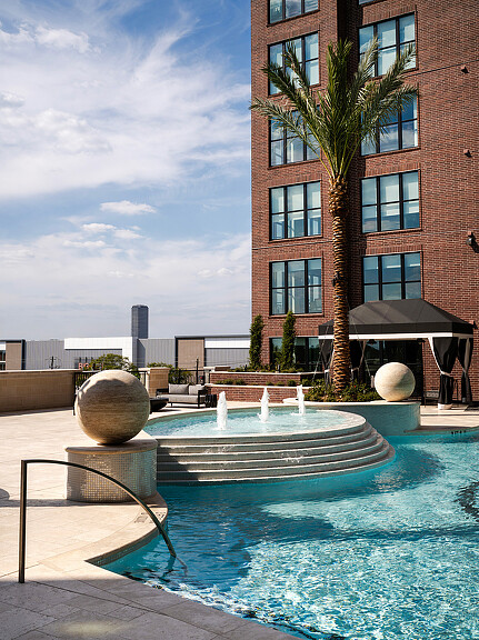 A pool with a building in the background.
