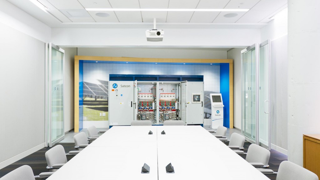 A room with white tables and chairs.