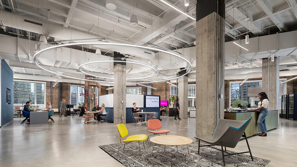 A large room with people and tables.