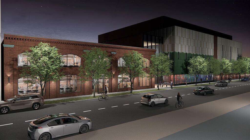 A building with cars and people on the street.