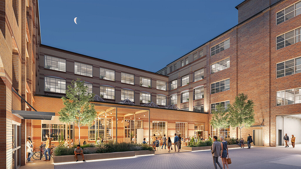 A group of people walking outside of a building.