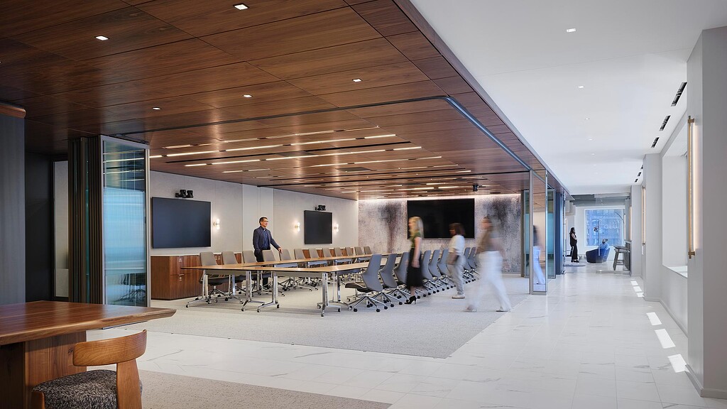 A group of people walking through a building.