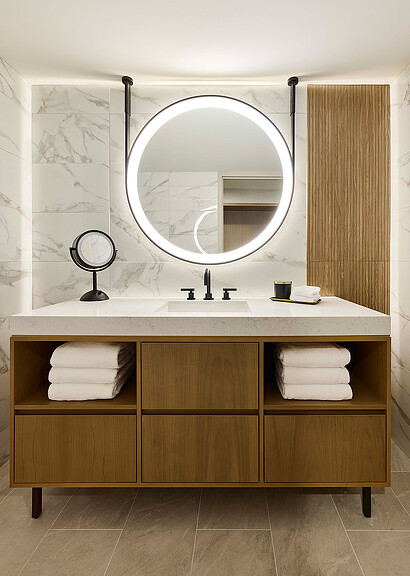 A bathroom with a large mirror.