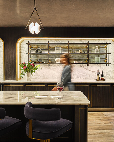 A person standing behind a bar.