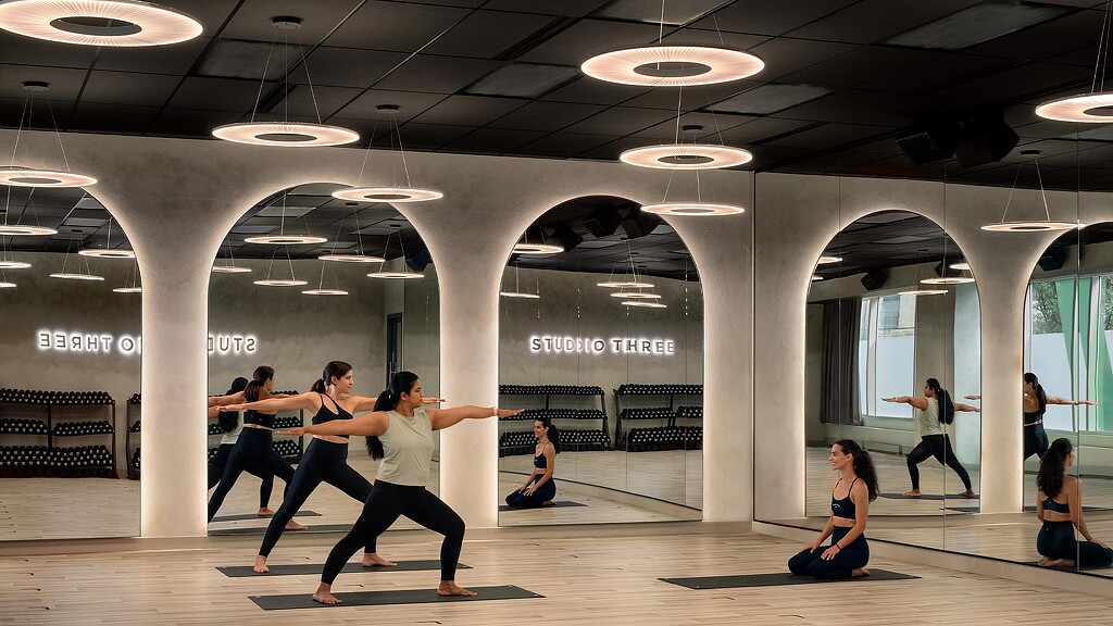 A group of people dancing in a large room.