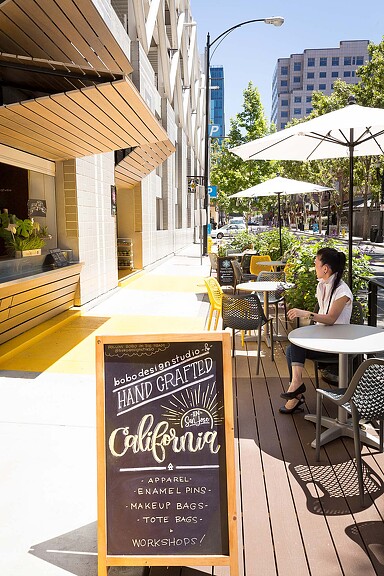 A person sitting at a table outside.