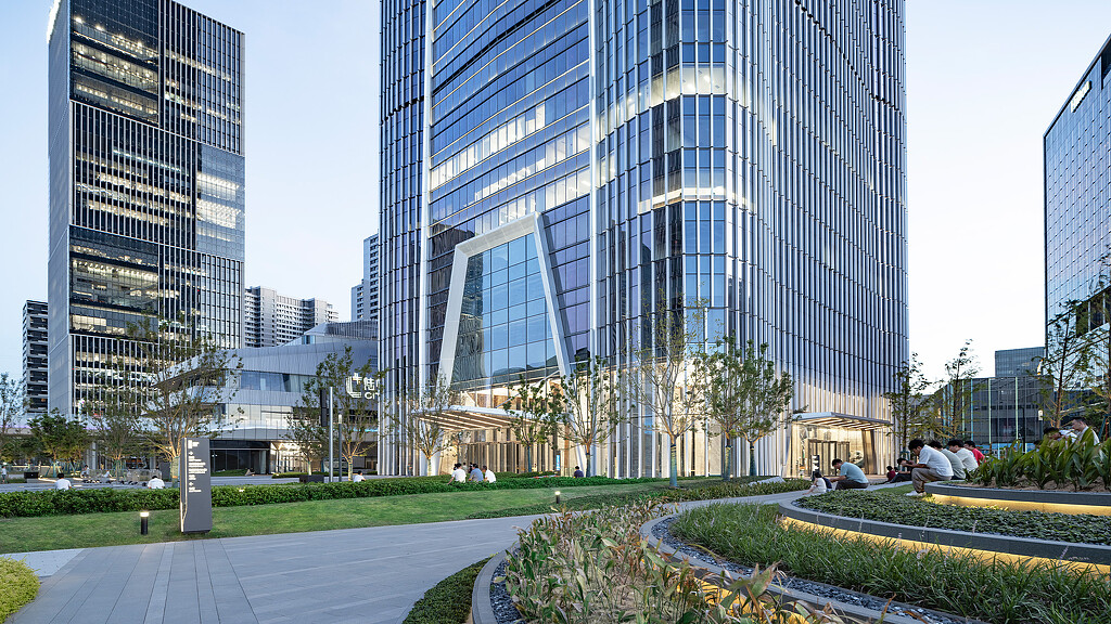 A group of people sitting outside of a building.