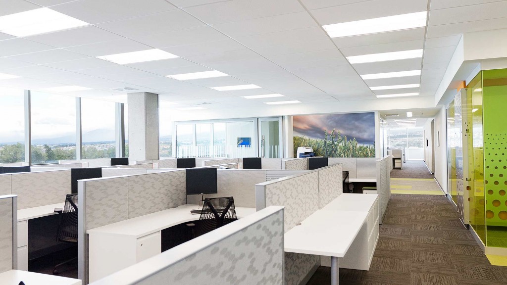 A room with white tables and chairs.