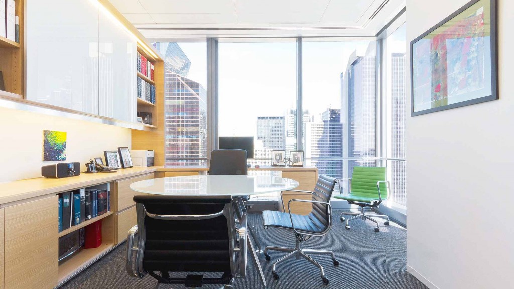 An office with a desk and chairs.