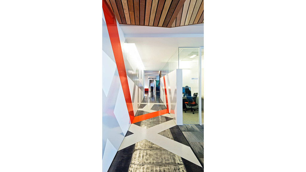 A hallway with a red and white striped wall.