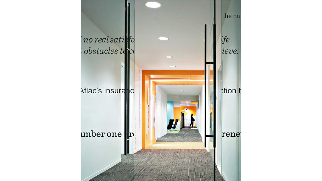 A hallway with a glass door.