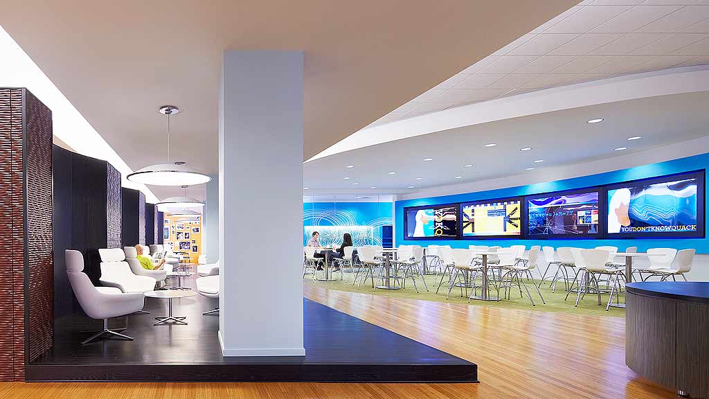 A room with a large screen and chairs.