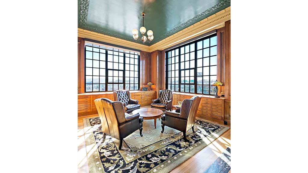 A living room with a rug and chairs.