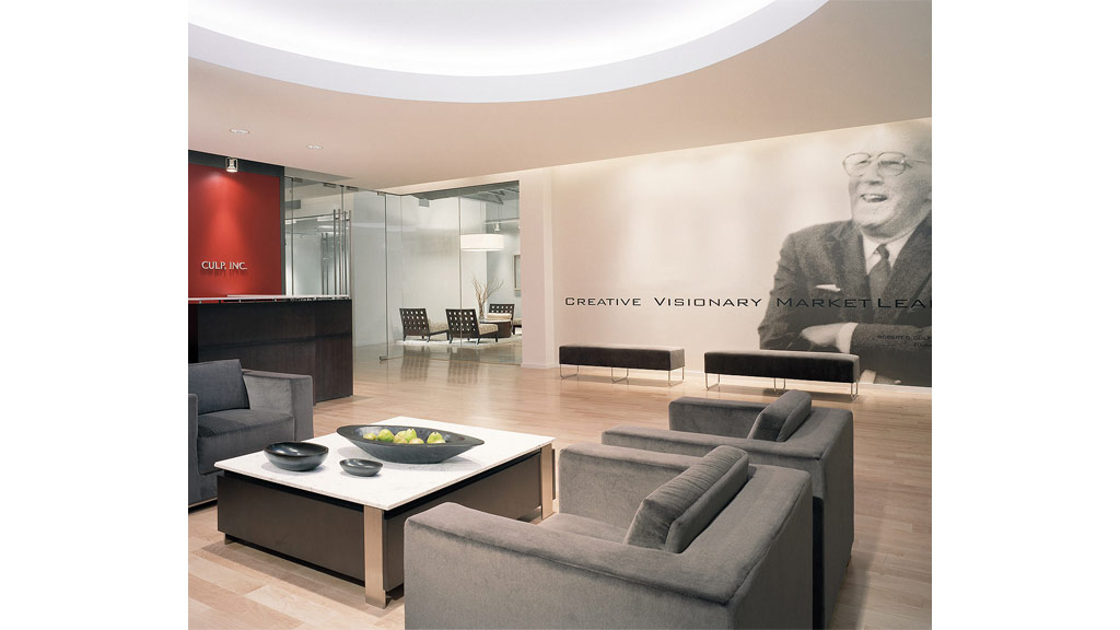 A room with a couch and a table with a tv on it.