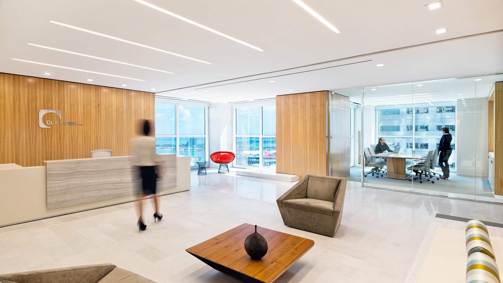 A room with a couch and a table and chairs.