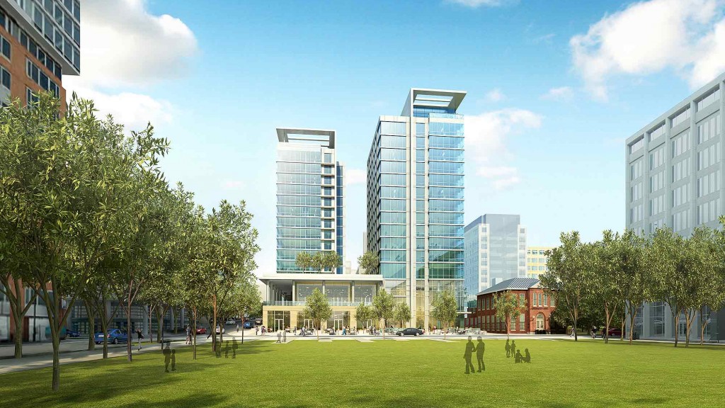 A park in front of a group of buildings.