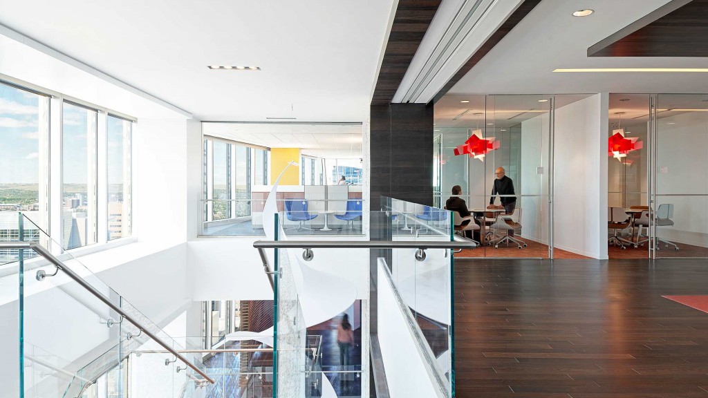 A large glass walled room with a large glass staircase.