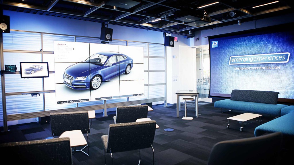 A room with chairs and a car in it.