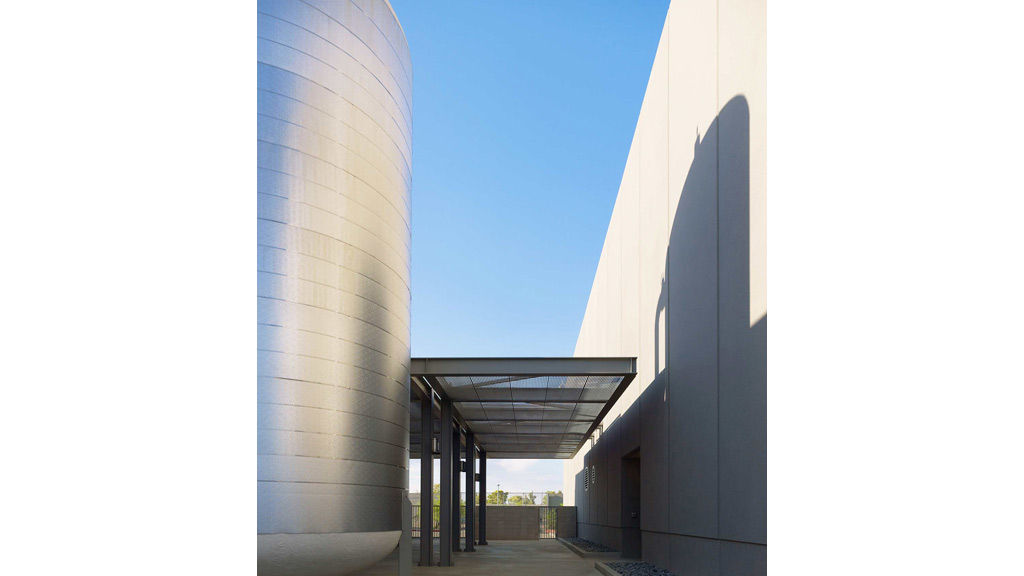 A walkway between two large white buildings.