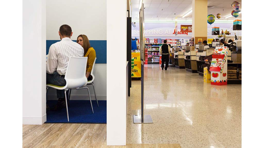 A man and woman sitting in chairs in a store.