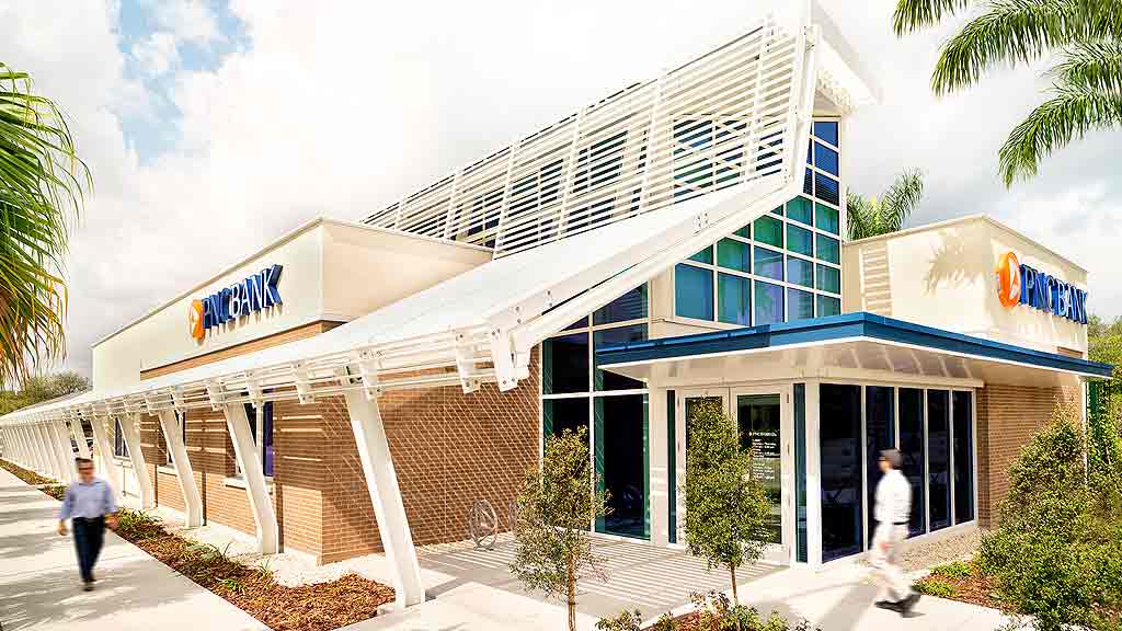 A building with a few people walking out front.