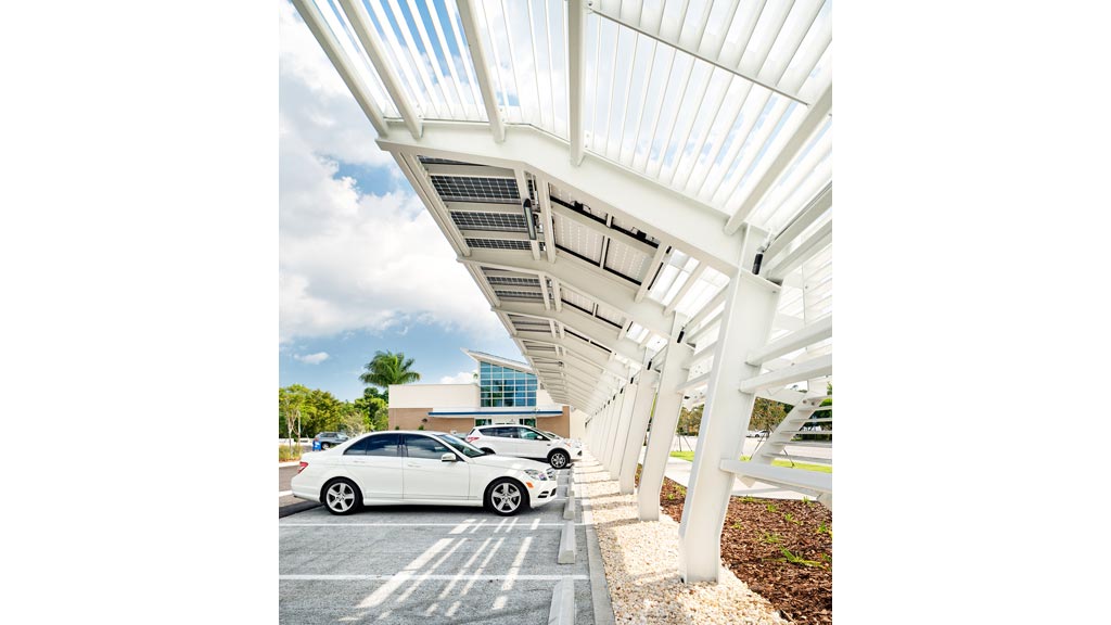 Cars parked under a bridge.