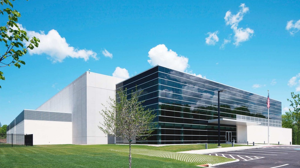 A building with a tree in front.