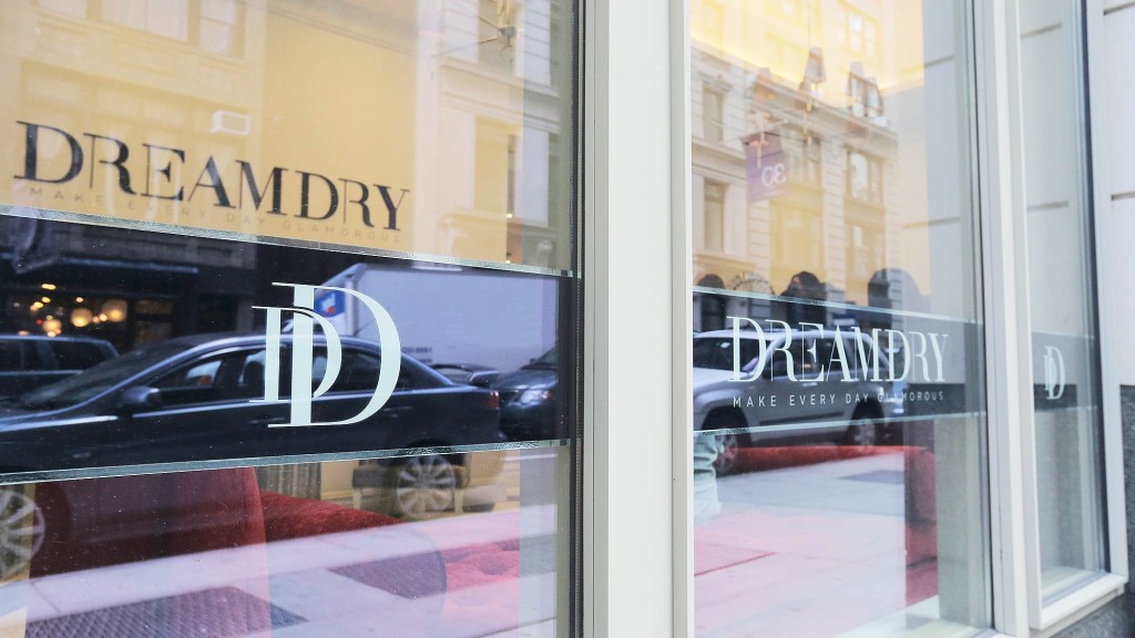 A window with a reflection of a car and a building.