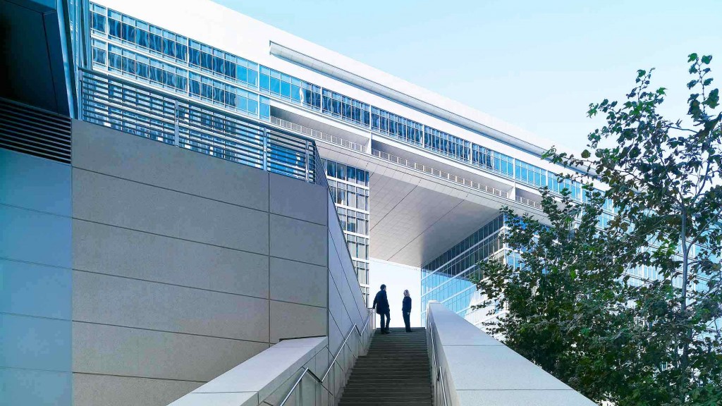 A building with a staircase and people walking up the stairs.