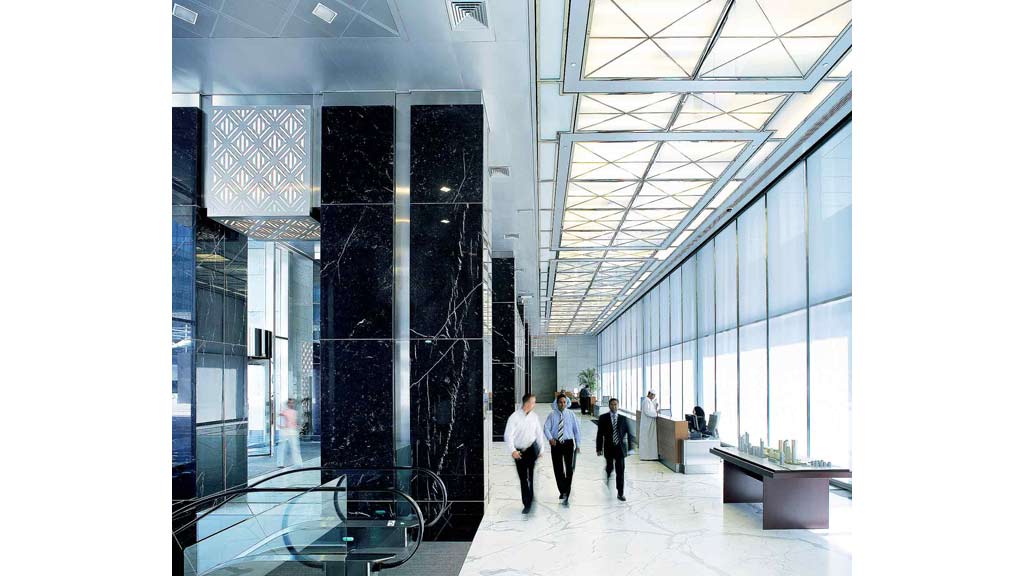 A group of people walking through a building.