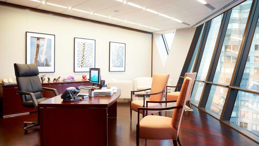 An office with a desk and chairs.