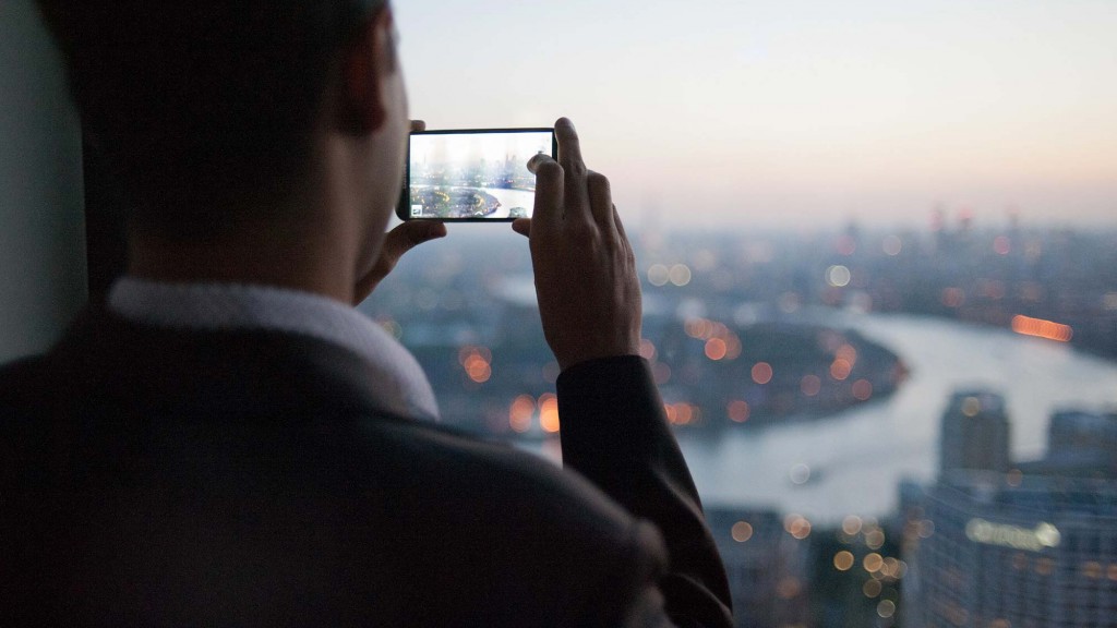 A man taking a picture of a city.
