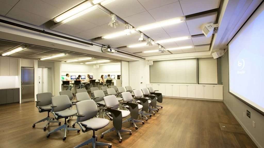 A room with chairs and a projector screen.