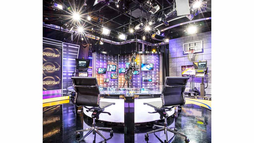 A table with chairs and a game board in a room with lights.