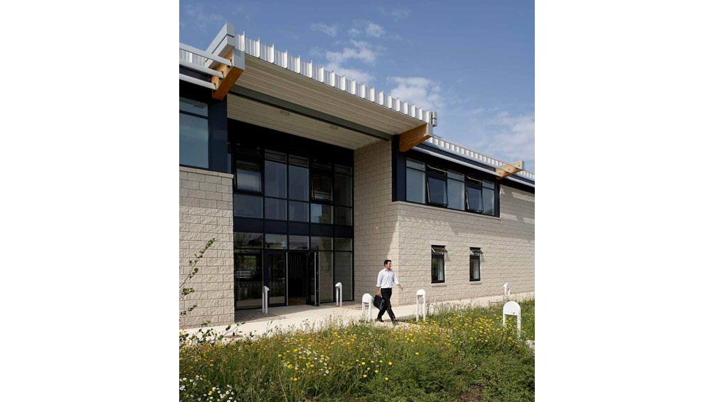 A person walking outside of a building.