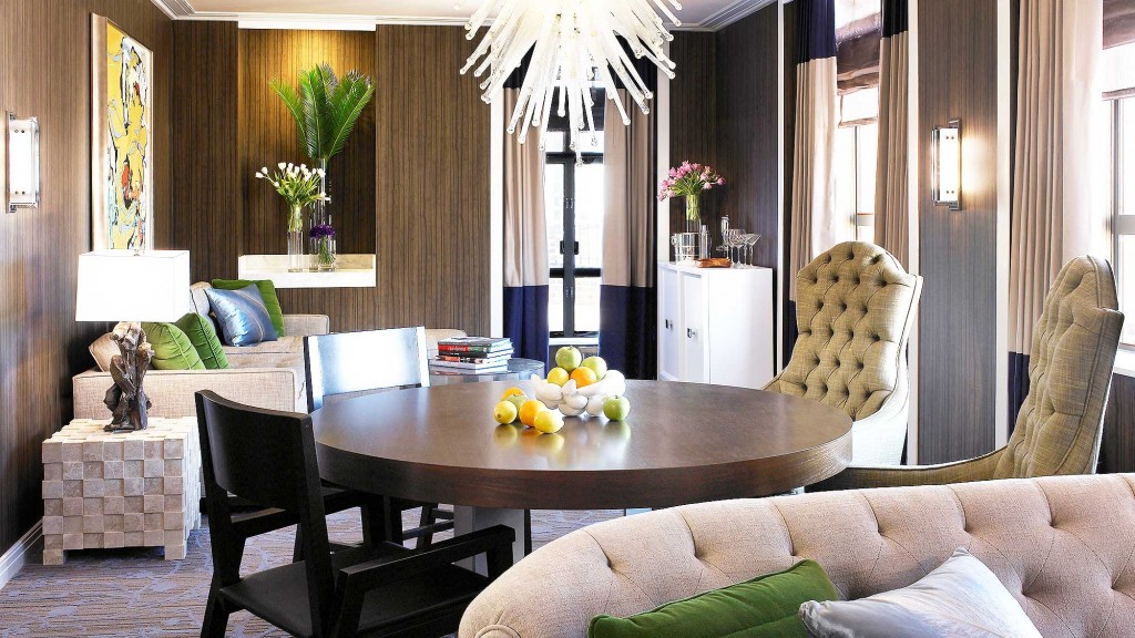 A living room with a large chandelier and a table.