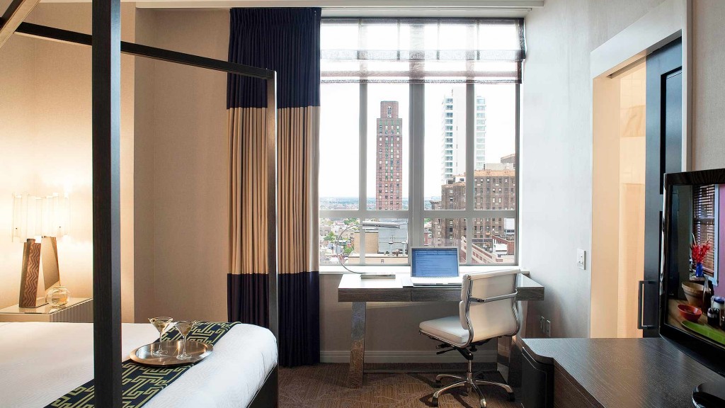 A bedroom with a large window.