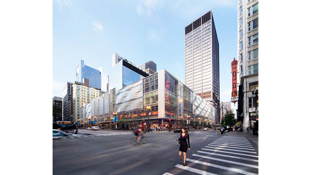 A person standing in a crosswalk in a city.