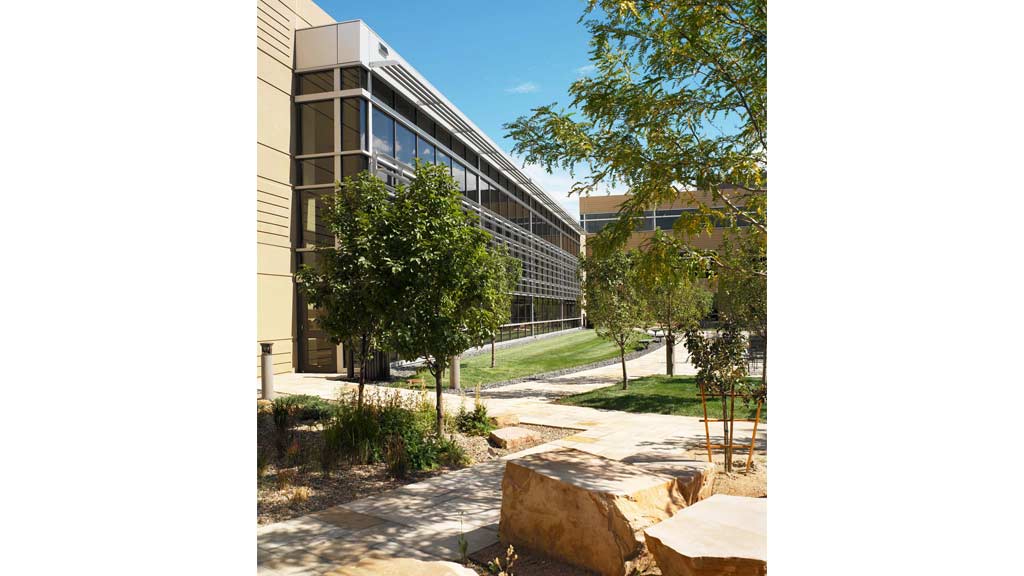 A building with trees and rocks.