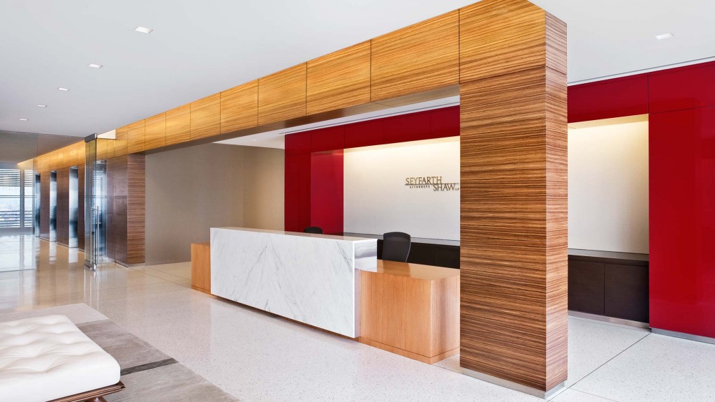 A room with a large screen and a desk.