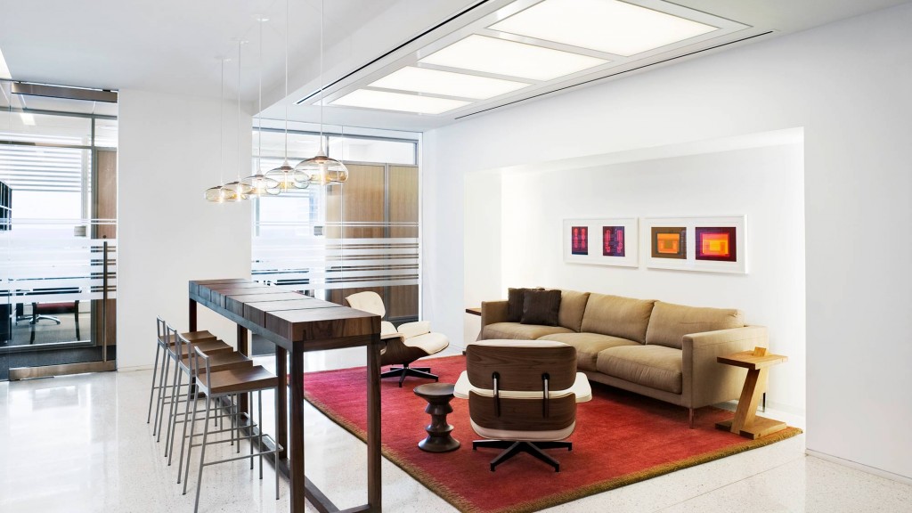 A living room with a table and chairs.