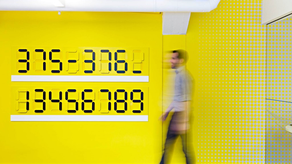 A person standing in a yellow wall.