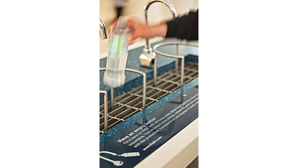A person pouring liquid into a glass.