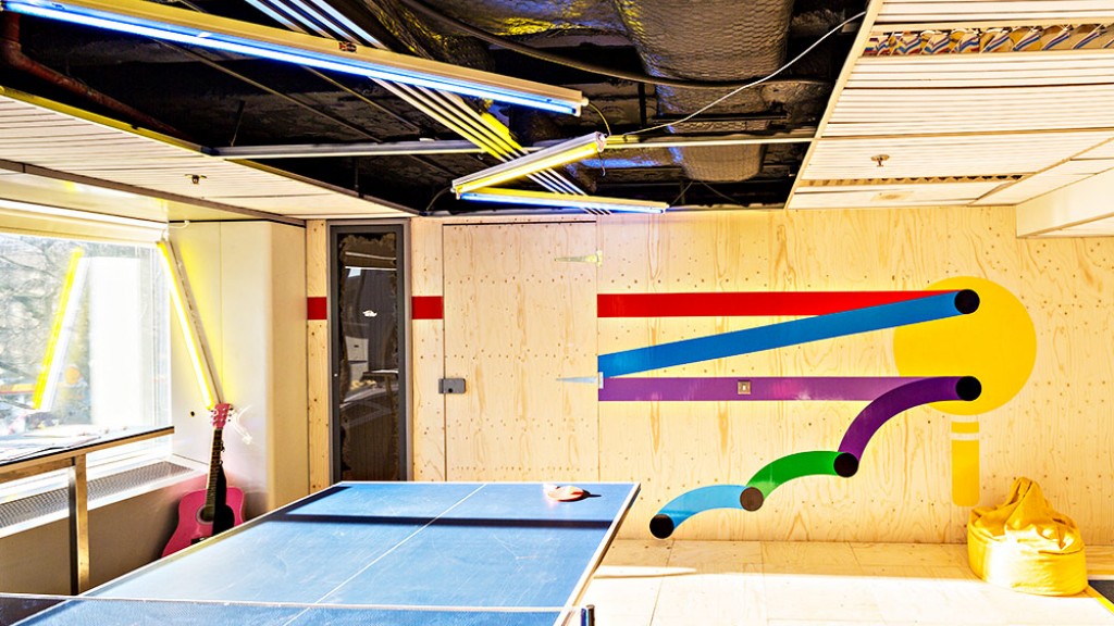 A room with a pool table and a large ceiling fan.