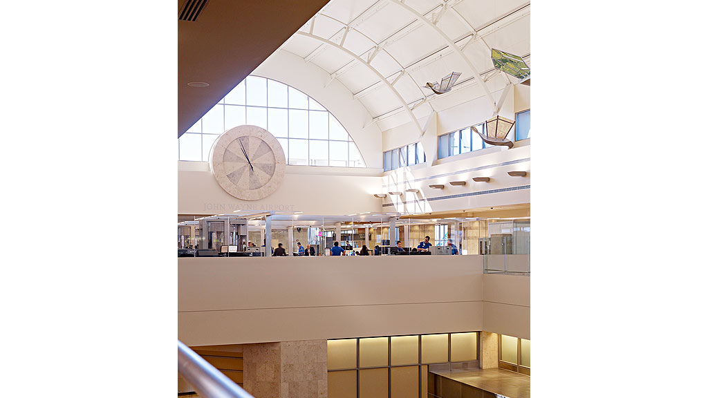 A clock on the ceiling of a building.