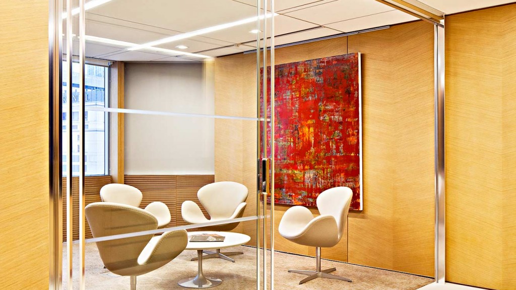 A room with a glass door and a table with chairs.