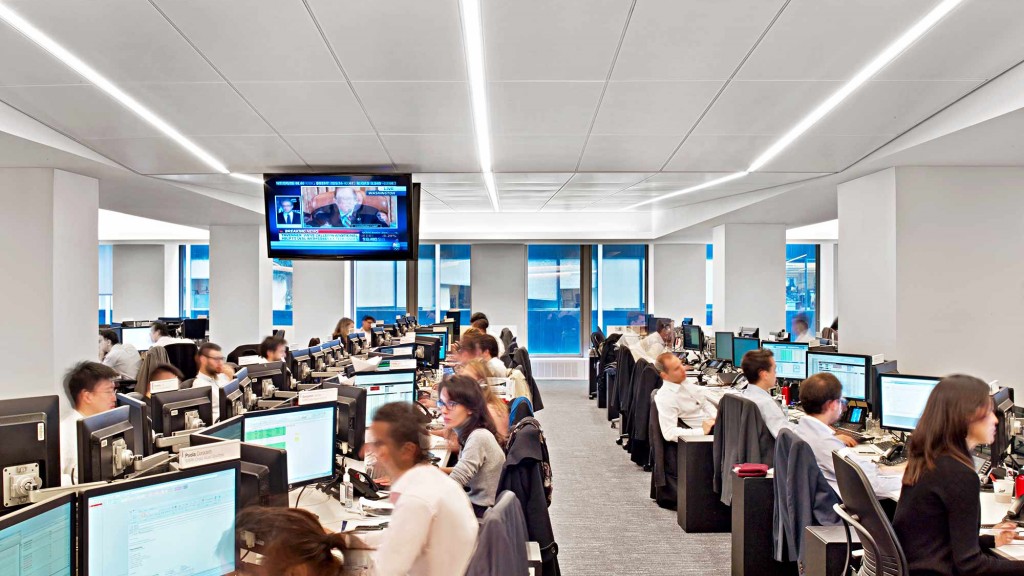 A group of people sitting in a room with computers.