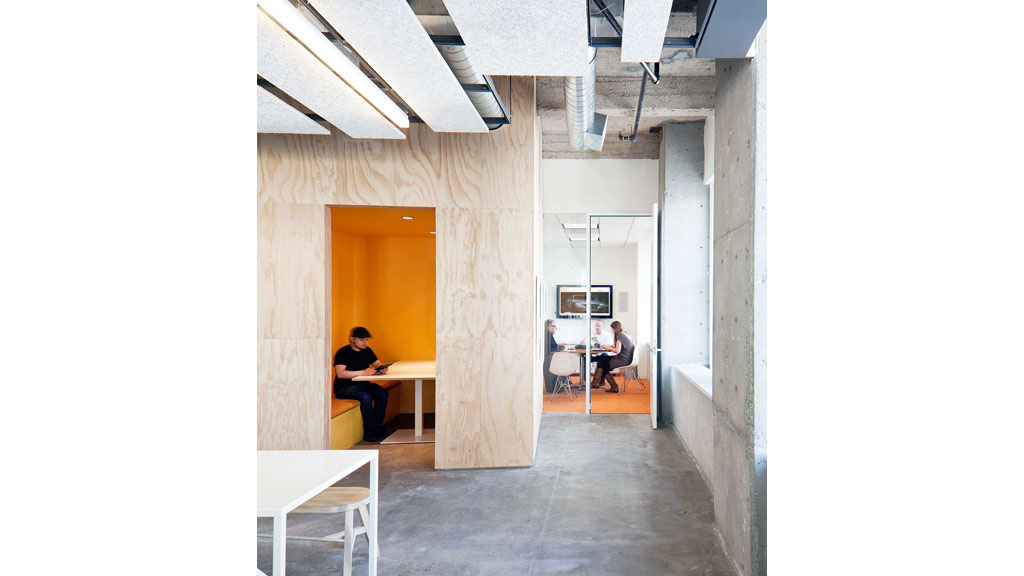 A couple of people sitting at a table in a room with white walls.