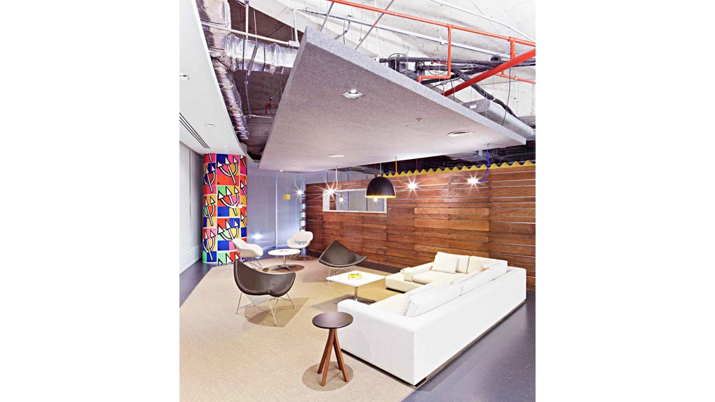 A room with a couch and chairs.